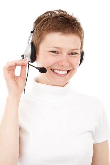 Insurance agent happily helping a customer with service over the phone
